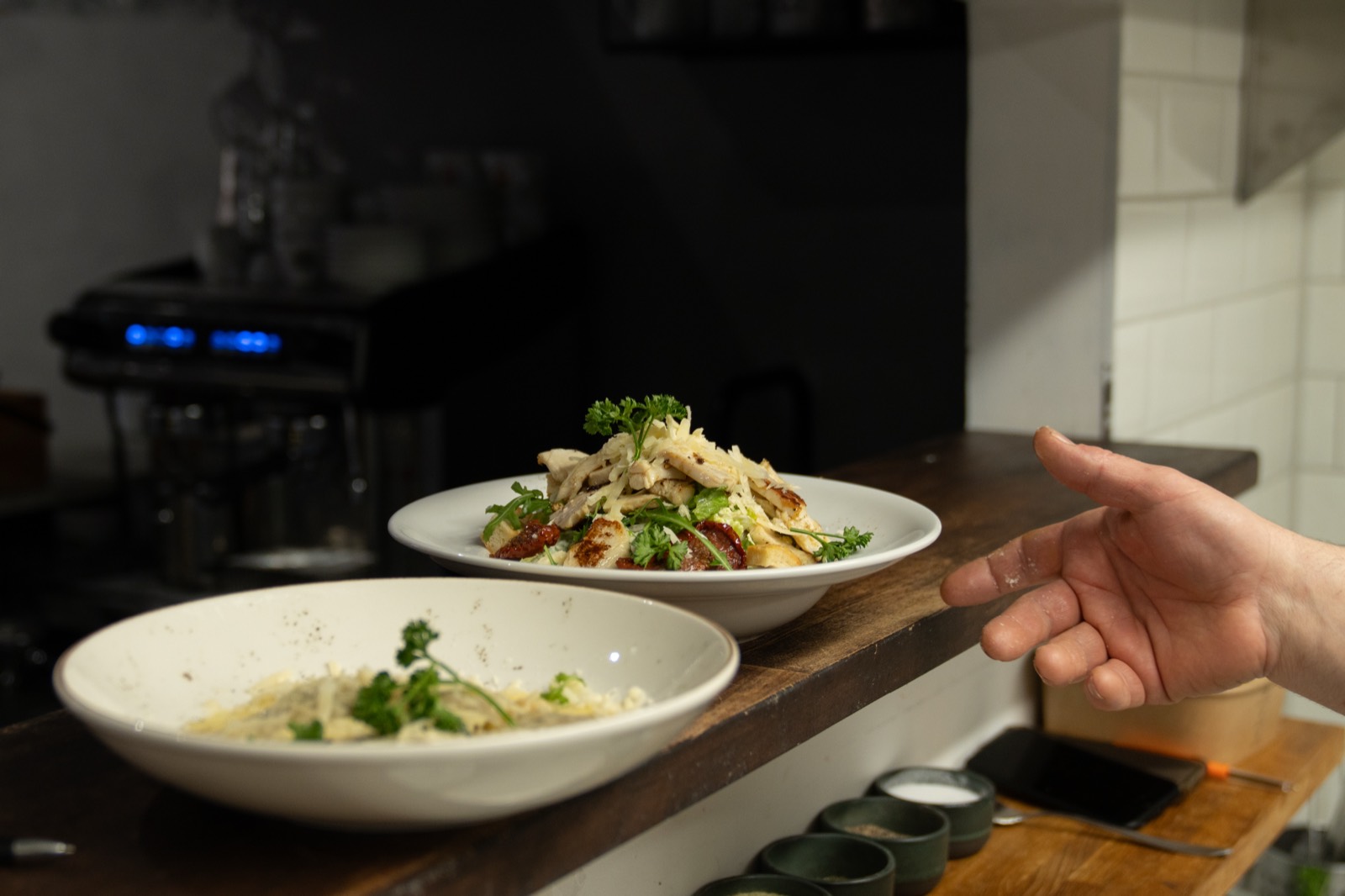 A pair of dishes finished under warm kitchen light.